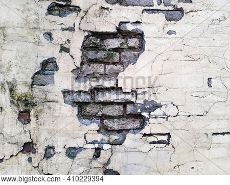 Background Of A Crumbling Brick Wall Close-up. The Texture Of A Crumbling Wall