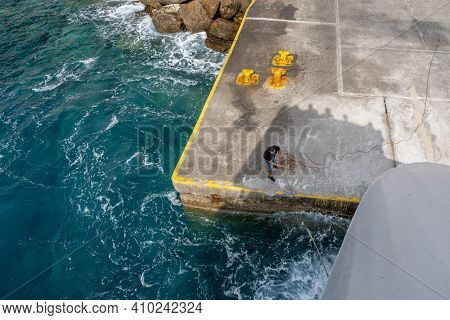 Sikinos, Greece - September 26, 2020: A Man Is Holding A Rope In The Alopronia Port Of Sikinos. Cycl