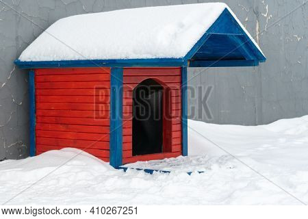 Red Wooden Doghouse Covered With Snow. Doghouse