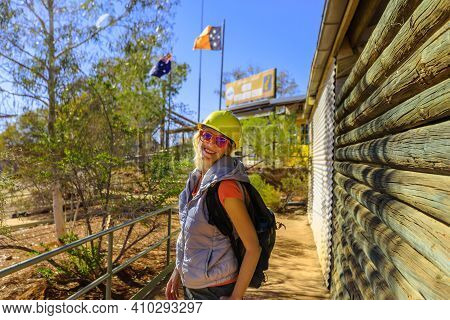Happy Woman Tourist With Miners Helmet At Entrace Of Information Centre In Battery Hill Mining Cente