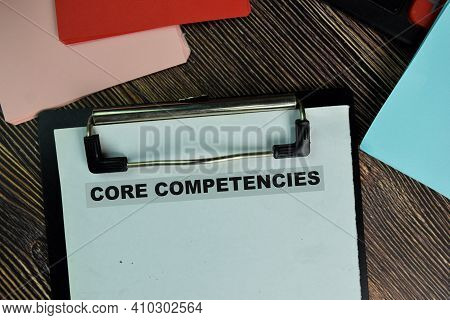Core Competencies Write On A Paperwork Isolated On Wooden Table.