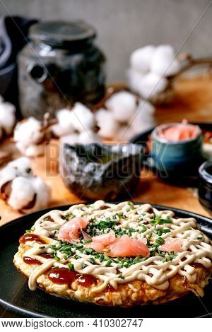 Homemade Japanese Fast Food Okonomiyaki Cabbage Pancake With Onion, Pickled Ginger, Mayo Sauce On Bl
