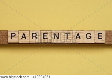 Word Parentage Made From Wooden Letters Lies On A Yellow Table
