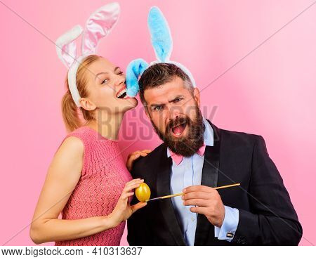 Easter Family. Happy Bunny Couple With Rabbit Ears Painting Eggs.