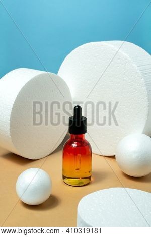 Glass Bottle With Pipette Essential Oil, Serum On Blue And Bige Background. Face, Skin Care Organic 
