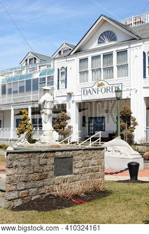 PORT JEFFERSON, NY - April 6, 2015: Bayles Park at Danfords Hotel and Marina. Danfords Hotel fronts Bayles Park in Port Jefferson, Long Island, New York.