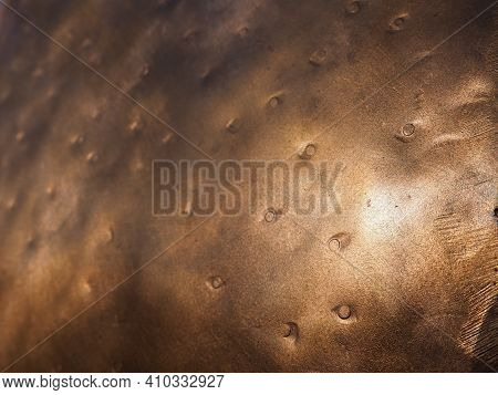 Metal Bronze Textured Plate. Bronze Or Copper Polished Surface With Dents, Scratches And Indentation
