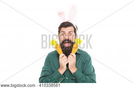 Easter Surprises. Cheerful Guy Holding Carrots. Spring Holiday Greeting. Eastertide. Surprised Beard
