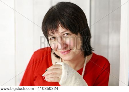 A Broken Arm. Close-up Of The Plaster. A Lady In A Red Jacket With A Bright Manicure. Exercises To R