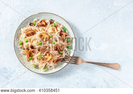 Vegan Konjac Pasta With Mushrooms And Green Peas, Shot From Above With Copy Space