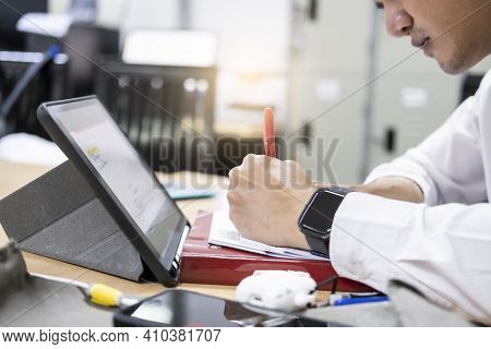 Asian Education Man Reading Books So Looking Tablet In Office To Prepare For The Exam Entrance To Le