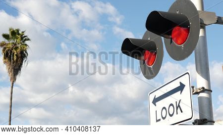 Level Crossing Warning Signal In Usa. Crossbuck Notice And Red Traffic Light On Rail Road Intersecti