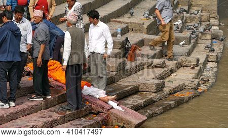 Kathmandu, Nepal - 8 October 2018: Local Hindu People, Traditional Cremation Ceremony At The Burning