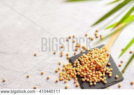 Chickpeas With Green Botanic Plant On White Background, Top View Flat Lay Copy Space. Plant Based Fo