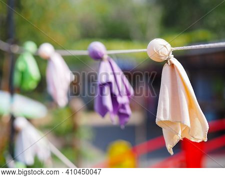 Close Up Japanese Fabric Rain Doll Or Teru Teru Bouzu Hanging In Row At Japan Garden.
