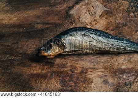 Dried Fish Lies On A Wooden Table Top View Texture Background Image