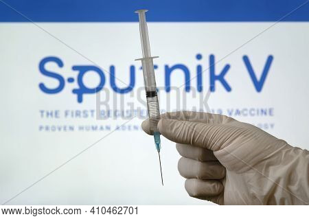 The Vaccine Sputnik V Against Coronovirus Infection Covid 19 And A Syringe On White Background.