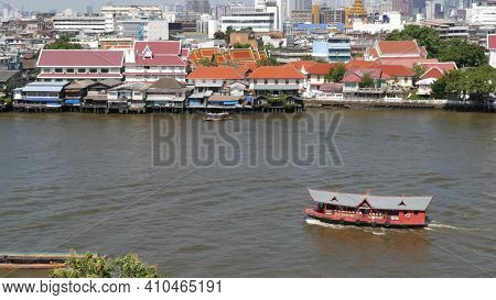 Oriental Boat Floating On River In Krungthep City. Modern Transport Vessel Floating On Calm Chao Pra