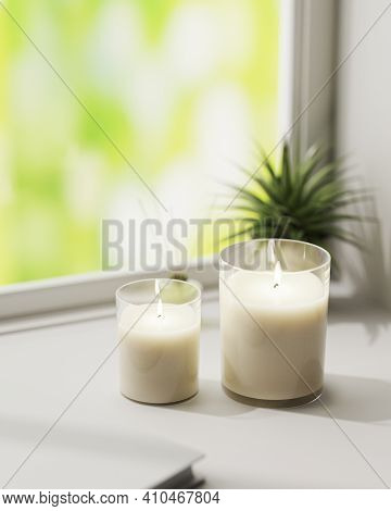 Scented Candle, Burning White Aromatic Candles In Glass On White Surface With Green Plant On Backgro