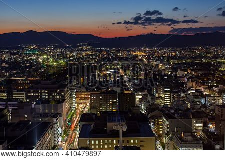 Cityscape Colorful Night View Against Cloudy Sky At Day Time