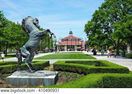 BROOKFIELD, ILLINOIS - MAY 27, 2017: Horse Statue and Carousel at the Brookfield Zoo The ride is popular attraction of the park with families and children.