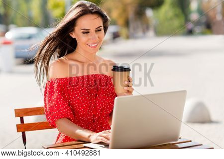 Photo Of Adorable Cute Young Lady Wear Red Off-shoulders Dress Drinking Tea Looking Modern Device Ou