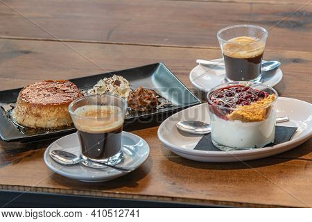 Flan Casero And Cheesecake Served In A Glass With A Berry Sauce.