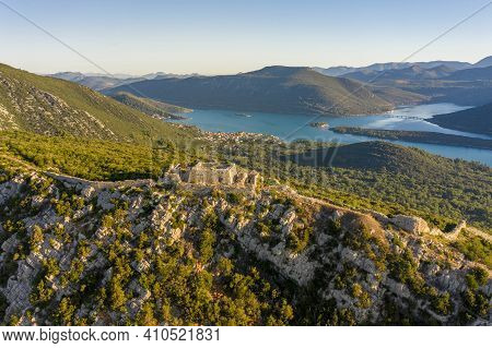Aerial Drone Shot Of Fortress Of City Of Ston On Top Of Hill In Ragusa Near Dubrovnik In Croatia Sun