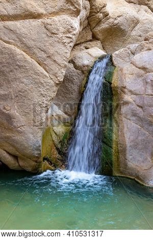 Small Waterfall Among The Rocks In Oasis Of Chebika Near Nefta At Sahara Desert, Tunisia. Motion Blu