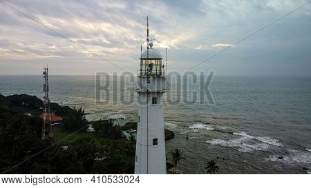 Aerial View Of Lighthouse Sea Rock Sunset Landscape. Sunset Lighthouse Scene. At Anyer Beach With No