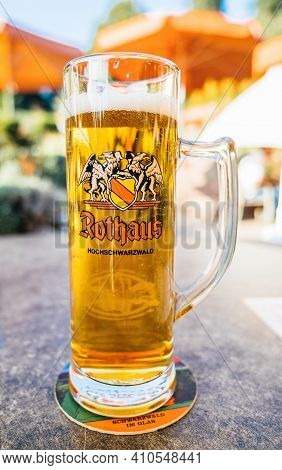 Germany - Oct 7, 2018: Close-up Of Tall Rothaus Hochschwarzwald Beer Pint With Terrace Defocused Sil