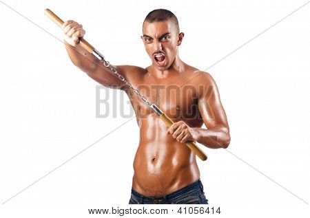 Mand i kampsport koncept med nunchucks