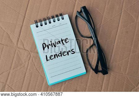 Eyeglasses And Notebook Written With Private Lenders.