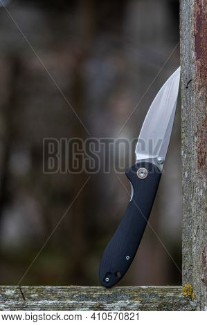 Pocket Knife For Daily Carry. Elegant Knife Design With Black Handle. Vertical Frame.