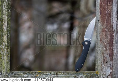 Photo Of A Knife On The Street In A Window Opening. Knife On An Old Window. Knife In A Window Frame.