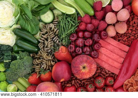 High fibre food for a healthy digestive system with fruit, vegetables, legumes and pasta. High in antioxidants, anthocyanins, vitamins, mineral, lycopenes and protein. Health care concept. Top view.