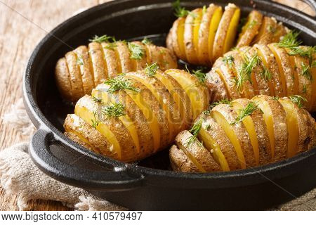 Swedish Baked Hasselback Potatoes Close-up On A Frying Pan On The Table. Horizontal