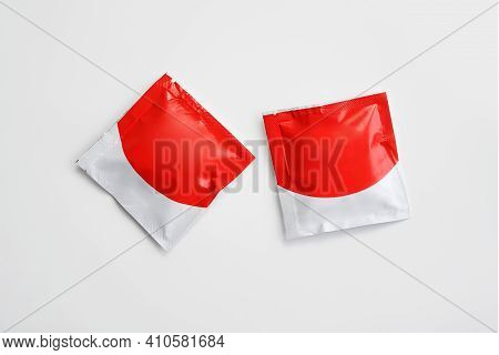 Unbranded Alcohol Swab Or Disinfectant Napkin In Red And White Package Isolated On White Background.