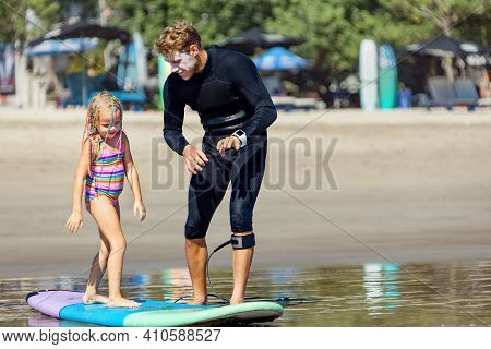 Little Surf Girl - Young Surfer Learn To Ride On Surfboard With Instructor At Surfing School. Active
