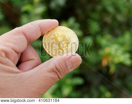 Man Hands Showing Golden Bitcoin.digitall Symbol Of A New Virtual Currency.