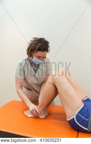 Physiotherapist And Patient In Global Postural Re-education Session, With Pandemic Protection Mask.