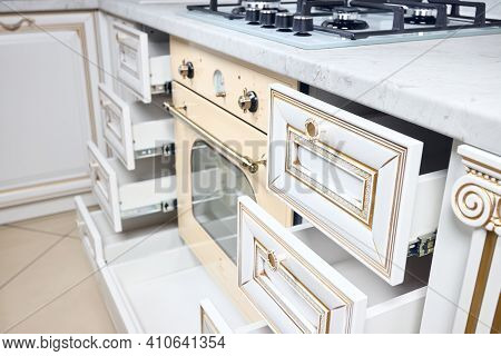 Kitchen Drawer Pullout Cabinet. Interior Of Modern Kitchen In Classic Antique Style With Golden Elem