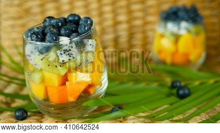 Colorful Tropical Mix Salad In Jar. Fresh Various Kind Of Raw Organic Berry And Fruit In Glass Bowl.
