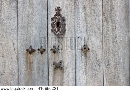 Rusty Metal Keyhole Cover Plate  And Metal Hinges Padlock On The Old Wooden Door.