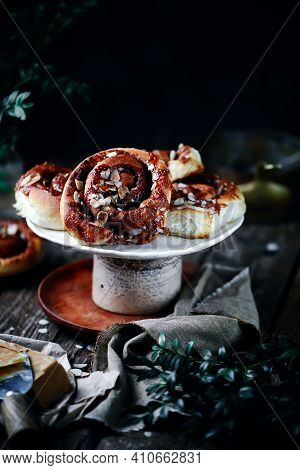 Brunost Caramel Cinnamon Buns A Wooden Table . Dark Rustic Photo.selective Focus