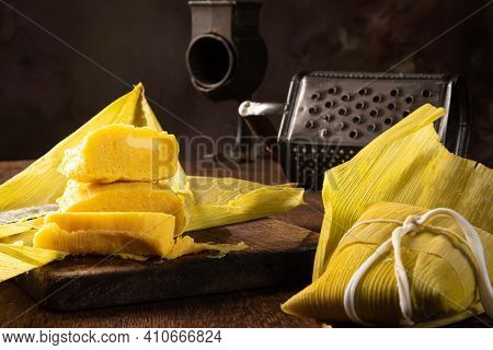 Pamonha, Brazilian Corn Food, Called Pamonha. On A Rustic Table With Knife And Old Corn Grater, Low