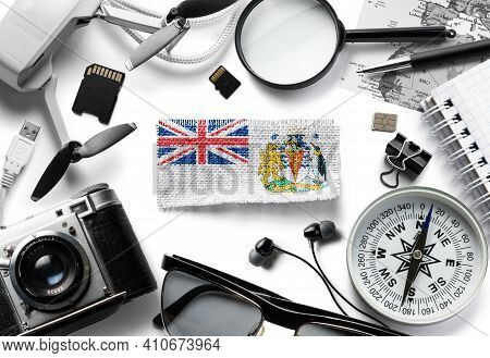 Flag Of British Antarctic Territory And Travel Accessories On A White Background.