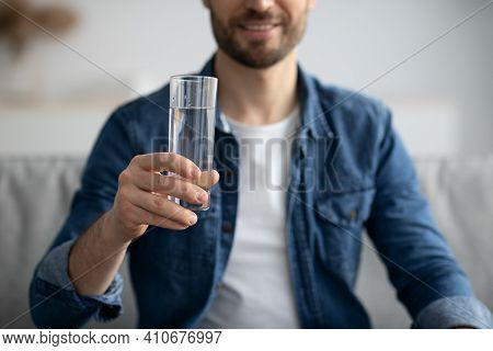 Cropped Of Middle-aged Man Holding Glass Of Spring Water At Home, Unrecognizable Healthy Bearded Man