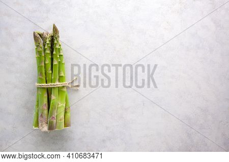 Bunch Of Asparagus Tied With Jute Rope On Whtie Background.