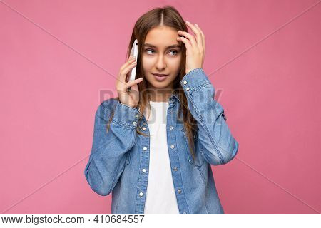 Photo Of Beautiful Sexy Thinking Young Blonde Woman Wearing Casual Blue Jean Shirt Isolated Over Pin